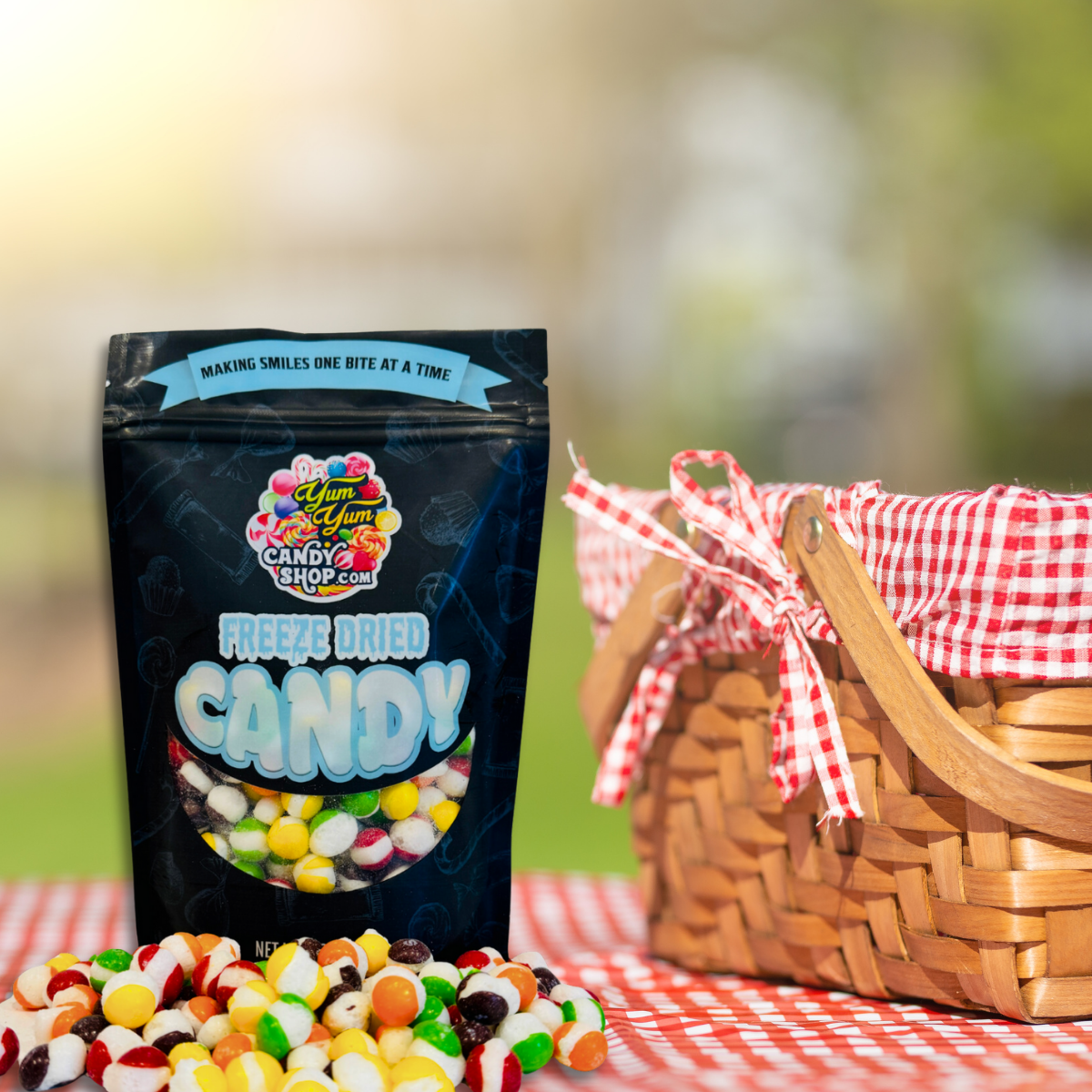 Freeze dried Rainbow Krunchies candy bag at picnic with fruit and basket