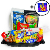 A variety of colorful candy and snack items arranged in a tray, including a dill pickle, bags of gummy candies, Takis chips, and a bottle of chamoy sauce, with chopsticks and a closable container included.