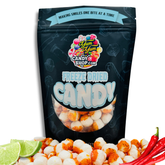 Black resealable bag of freeze-dried Chamoy Lemon Balls with limes and chili peppers displayed in front.