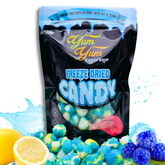 Freeze-dried sour blue raspberry lemon ballz candy in a Yum Yum Candy Shop bag with lemons and raspberries