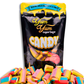 A colorful assortment of rainbow-striped licorice bits with a 'Yum Yum Candy Shop' packaging in the foreground.