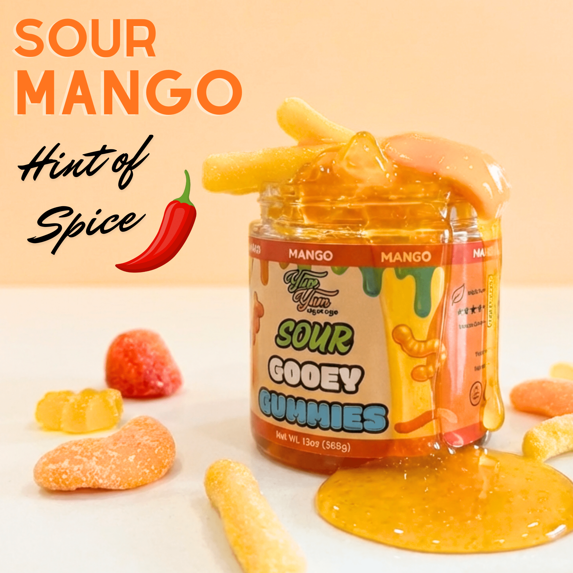 Slightly Spicy Sour Mango Gooey Gummies jar and orange thick syrup on an orange background