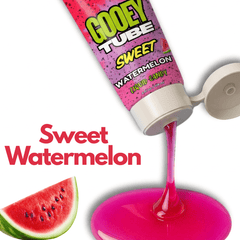 Gooey tube of sweet watermelon candy with a slice of watermelon on a white background