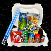 A Chamoy Pickle Poke Bowl Kit with Light Saber Chopsticks. The image shows a plastic bowl with various snack items like a pickle, bags of candy, and the chopsticks; set against a black background with stars.