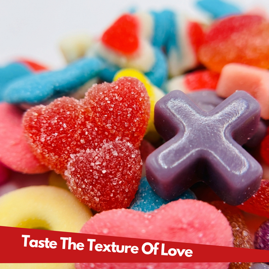 Bright love themed gummies in a pile on a white background