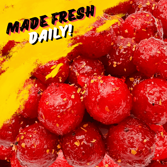 Bright red Chamoy Cherry Sours on a yellow background