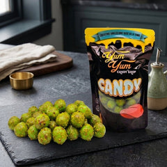 Yum Yum Candy Shop bag with green candy on a dark surface
