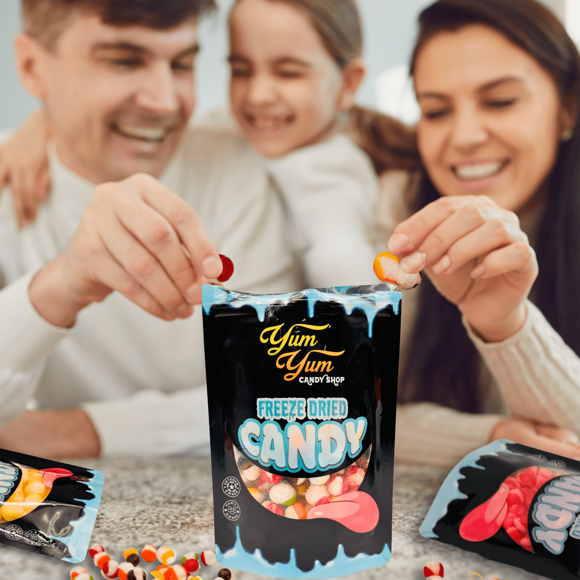Family smiling and sharing Yum Yum Candy Shop freeze dried candy from a resealable pouch on a kitchen counter