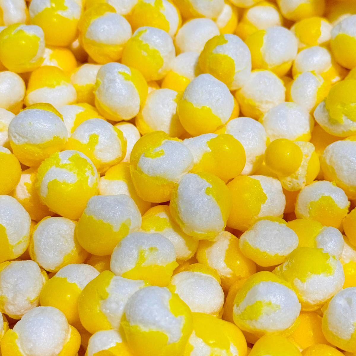 Close-up of assorted freeze-dried candies in bright yellow colors from the Trio Pack.