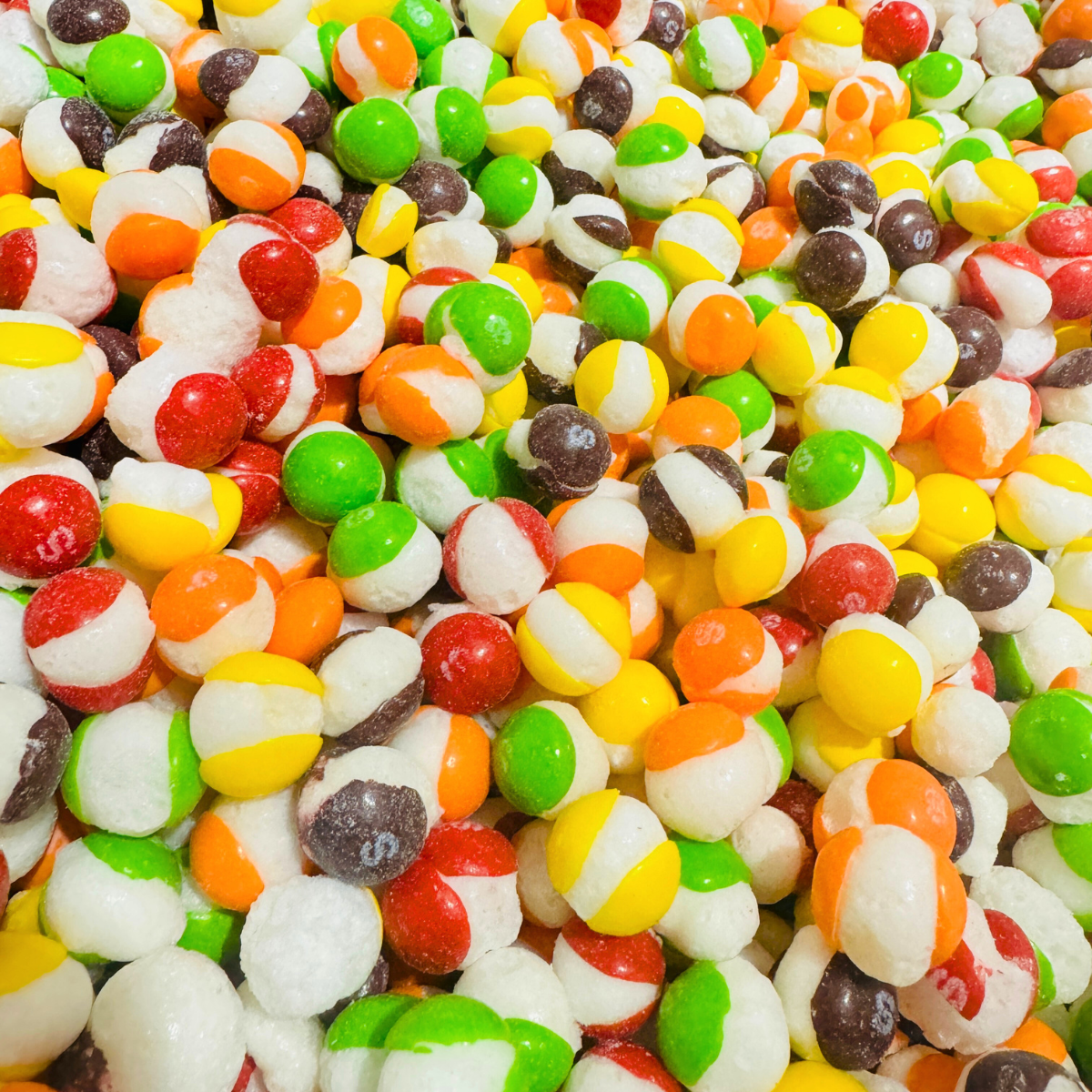 Close-up of assorted freeze-dried candies in bright rainbow colors from the Trio Pack.
