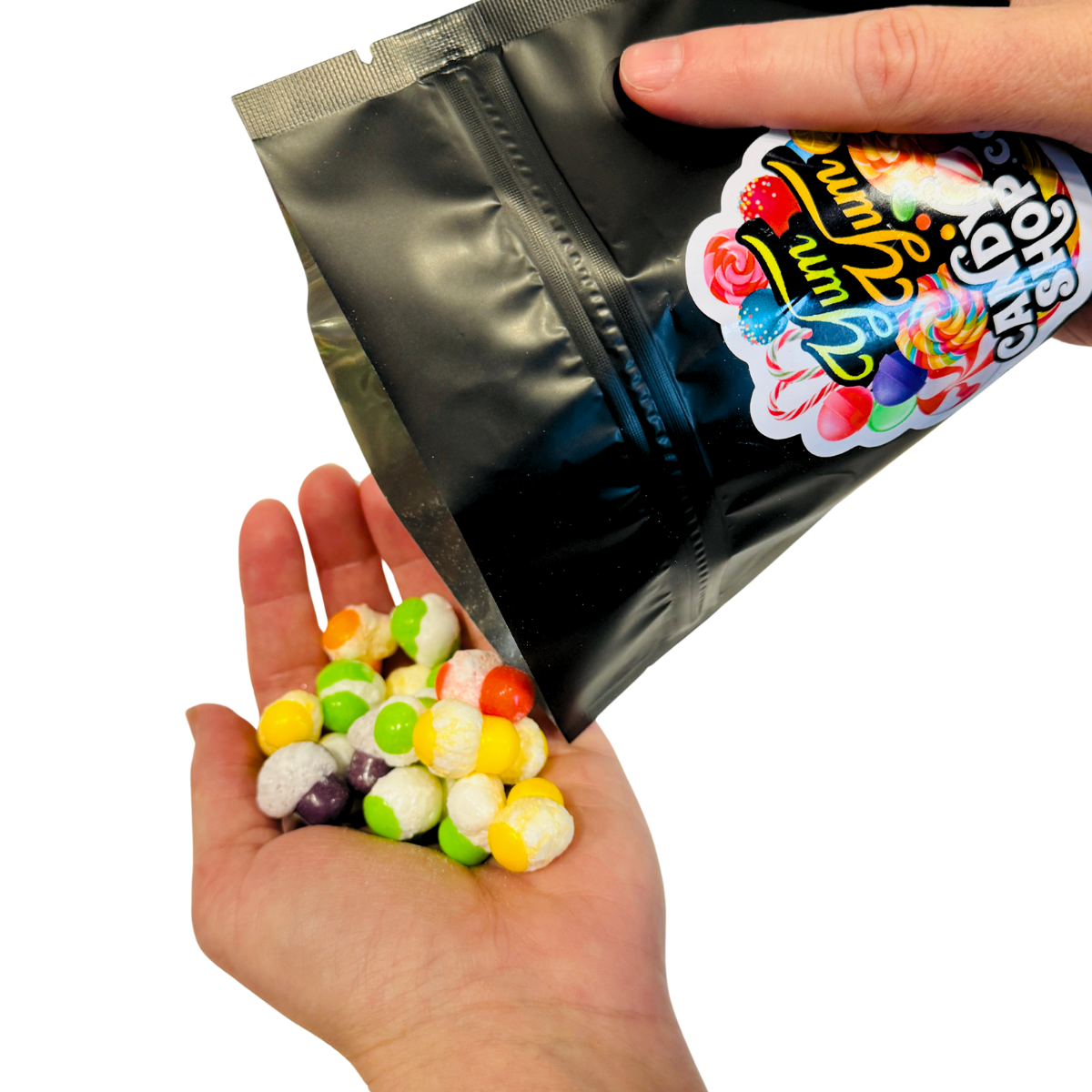 Hand pouring colorful freeze-dried candies from resealable bag.