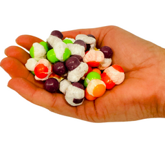 Hand holding assorted Freeze-Dried Itty Bitties candy.