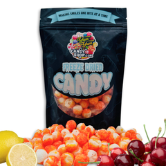 Main product bag of Freeze Dried Sour Cherry Lemon Balls with lemons and cherries around it.