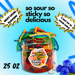 Jar of colorful gummy worms with 'Yum Yum Candy Shop' label on a blue background