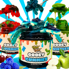 Gooey Gummies jar overflowing with sour gummy worms in blue raspberry, cherry, and green apple
