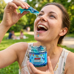Woman enjoying blue gummies outdoors with a jar labeled 'Sweet Gooey Gummies'.