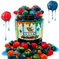 Jar of Yum Yum Candy Shop Gooey Gushables liquid candy with colorful gushable candies dripping on white background