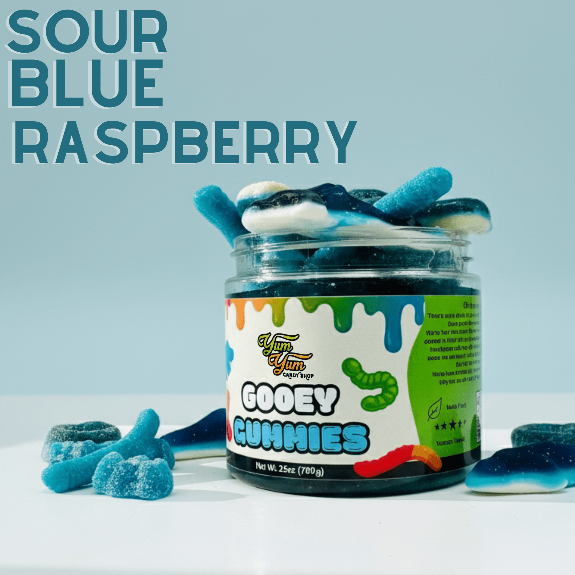 Jar of sour blue raspberry gooey gummies with blue gummy worms on a light blue background