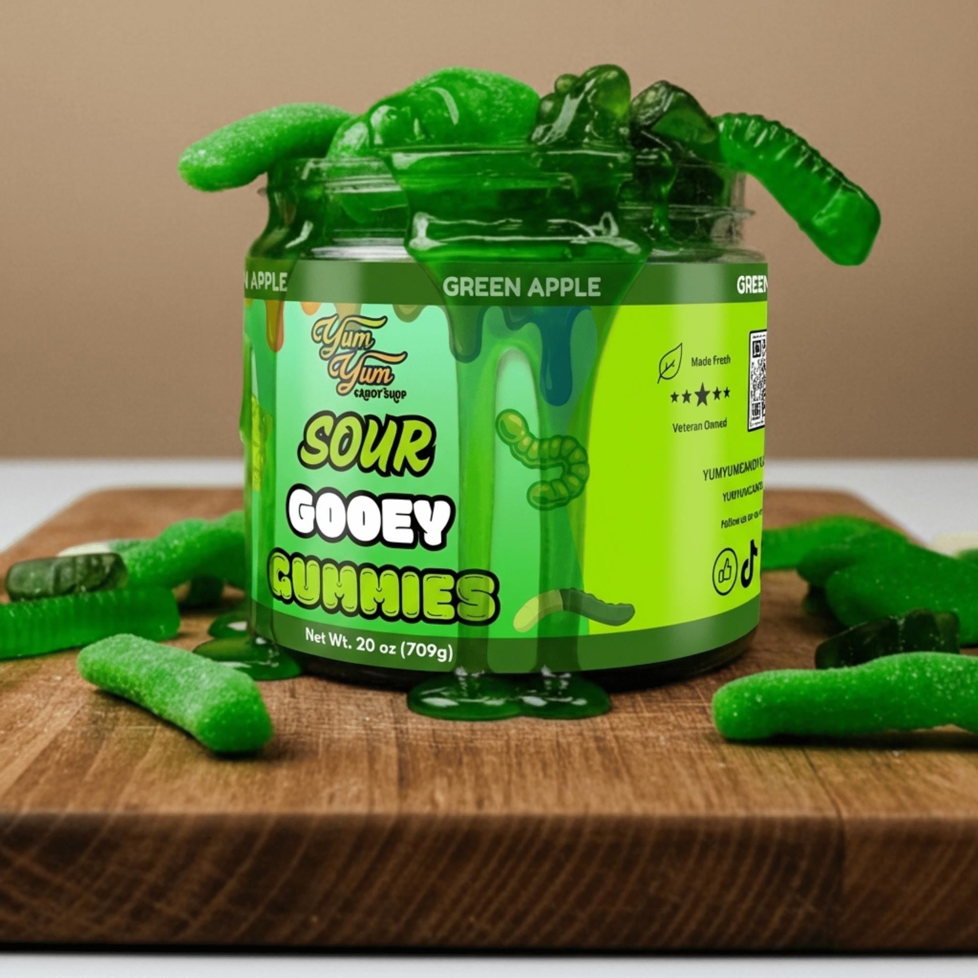 Jar of green apple sour gooey gummies on a wooden surface with a beige background