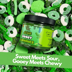 Jar of Sour green apple Gooey Gummies surrounded by green and white gummy candies on a green background.