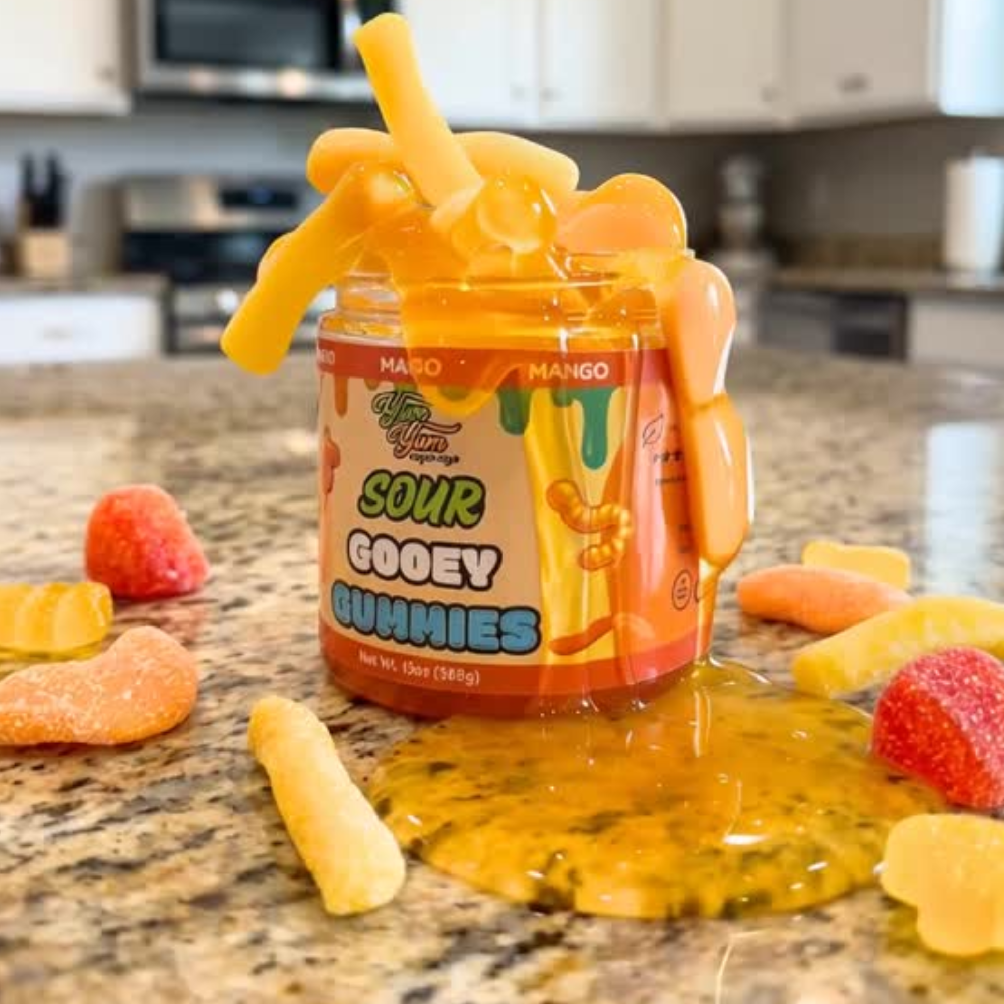Jar of Sour  Mango Gooey Gummies with gummy worms on a kitchen counter
