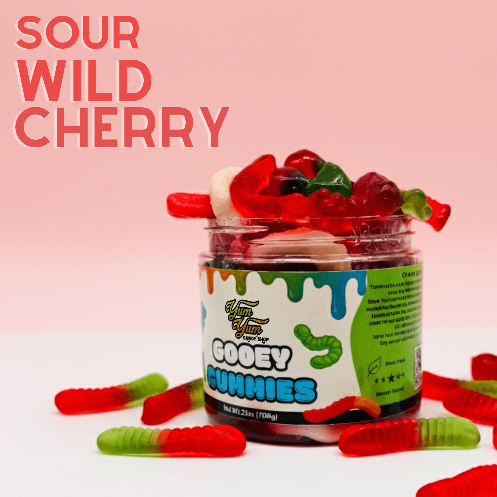 Jar of sour wild cherry gooey gummies with red and green gummy worms on a light pink background