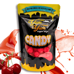 Bag of Yum Yum Candy Sours in Cherry  flavor, displayed with an assortment of fruits and the candy pieces visible.