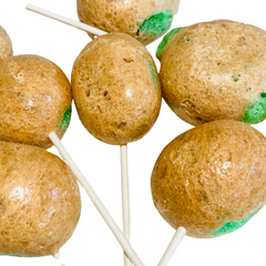 Close-up of freeze dried caramel apple pops on sticks